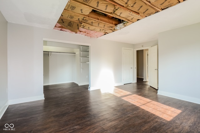 unfurnished bedroom featuring dark hardwood / wood-style floors and a closet