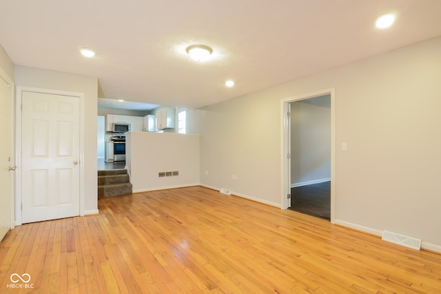 empty room with light hardwood / wood-style flooring