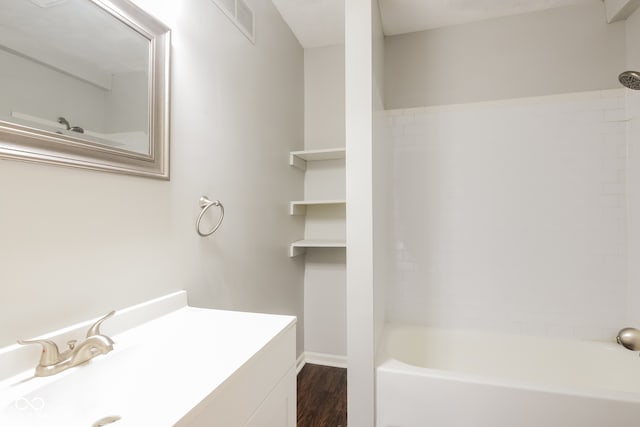 bathroom with vanity, bathtub / shower combination, and hardwood / wood-style flooring