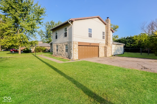 view of home's exterior featuring a lawn and a garage