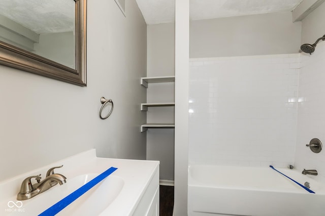 5060 Staughton Dr, Indianapolis, IN 46226 - bathroom featuring vanity, tub / shower combination, and a textured ceiling