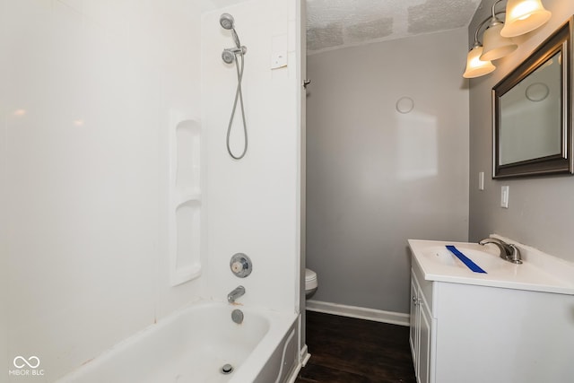 5060 Staughton Dr, Indianapolis, IN 46226 - full bath featuring vanity, a textured ceiling, baseboards, toilet, and washtub / shower combination