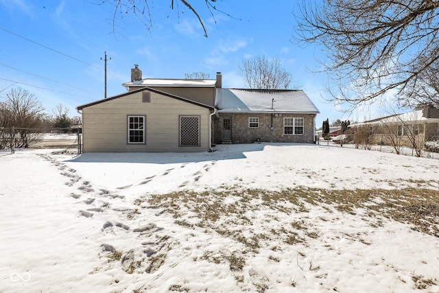 5060 Staughton Dr, Indianapolis, IN 46226 - snow covered house with a chimney