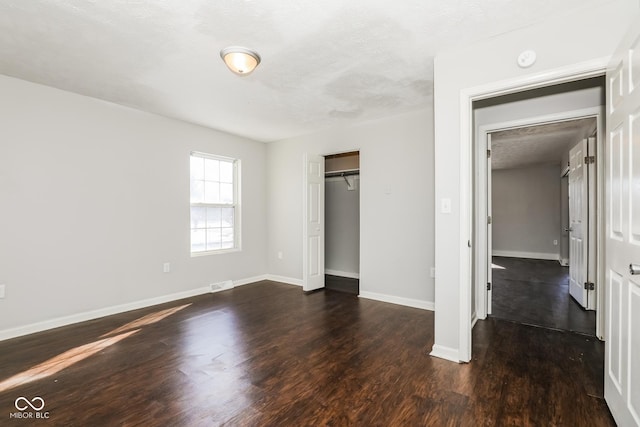 5060 Staughton Dr, Indianapolis, IN 46226 - unfurnished bedroom featuring wood finished floors, baseboards, and a closet