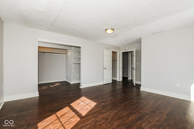 5060 Staughton Dr, Indianapolis, IN 46226 - unfurnished bedroom with a textured ceiling, baseboards, wood finished floors, and a closet