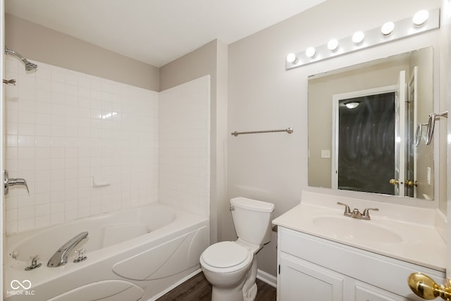 full bathroom featuring hardwood / wood-style floors, vanity, toilet, and tiled shower / bath combo