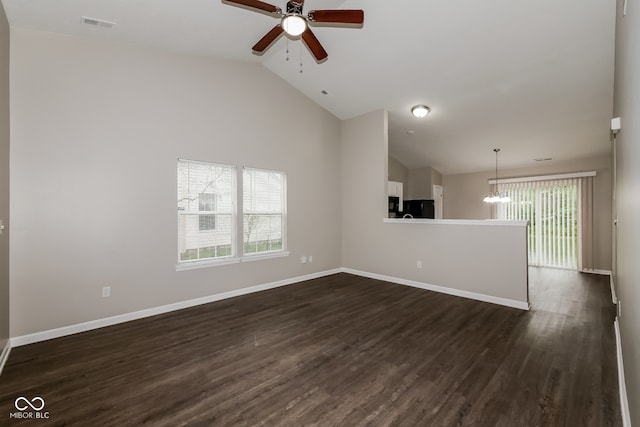 unfurnished living room featuring dark hardwood / wood-style flooring, high vaulted ceiling, and ceiling fan with notable chandelier