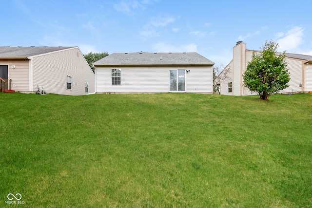 rear view of house with a lawn