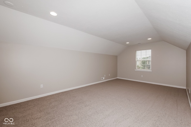 bonus room with carpet and vaulted ceiling