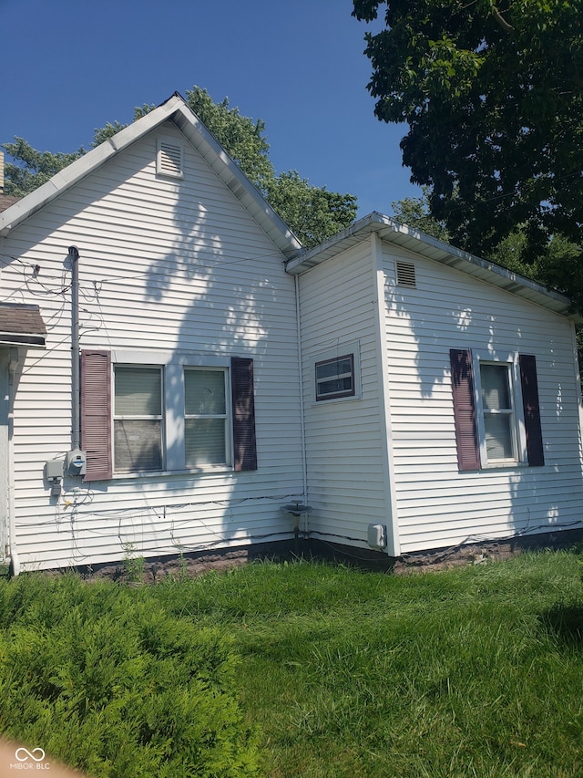 view of side of property with a yard