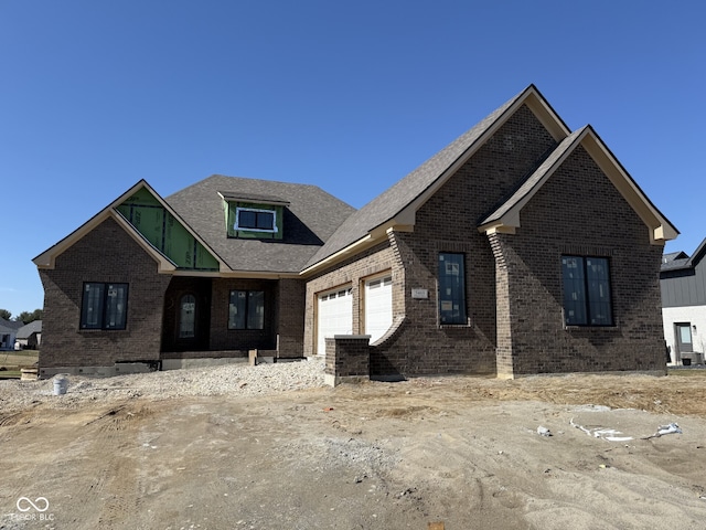 view of front facade featuring a garage and brick siding