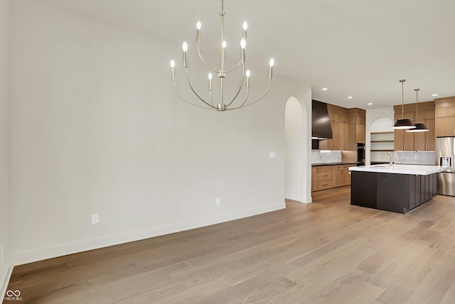 5469 Harness Dr, Greenwood, IN 46143 - kitchen with appliances with stainless steel finishes, arched walkways, light wood-style flooring, and recessed lighting