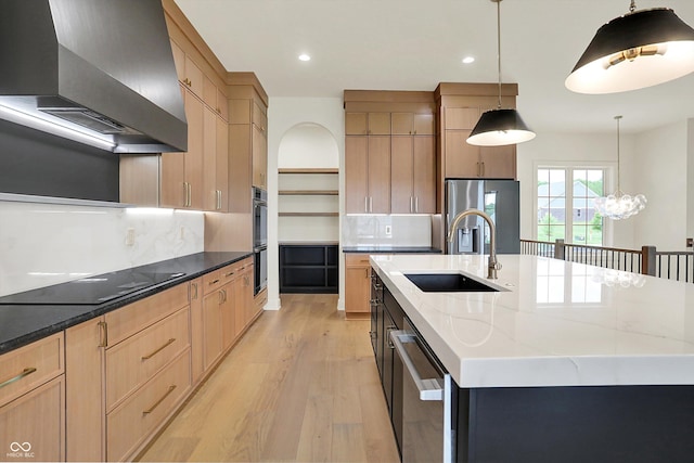5469 Harness Dr, Greenwood, IN 46143 - kitchen with wall chimney range hood, a sink, black appliances, light wood-style floors, and a center island with sink