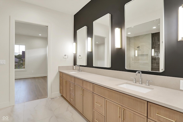 5469 Harness Dr, Greenwood, IN 46143 - bathroom with double vanity, marble look tiles, a shower, and baseboards