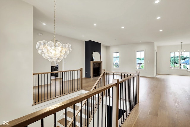 5469 Harness Dr, Greenwood, IN 46143 - corridor with a chandelier, recessed lighting, an upstairs landing, light wood-style floors, and baseboards
