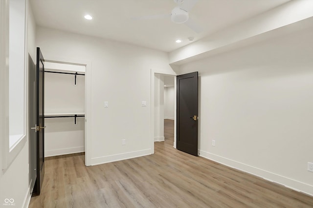5469 Harness Dr, Greenwood, IN 46143 - unfurnished bedroom with light wood finished floors, recessed lighting, baseboards, a spacious closet, and a closet