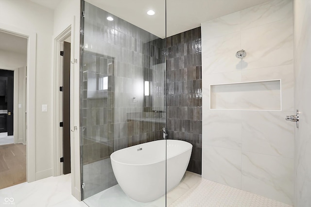 5469 Harness Dr, Greenwood, IN 46143 - bathroom featuring a soaking tub, recessed lighting, a tile shower, and tile walls