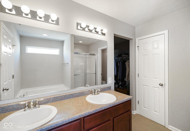 full bathroom featuring tile patterned flooring, plus walk in shower, vanity, and toilet