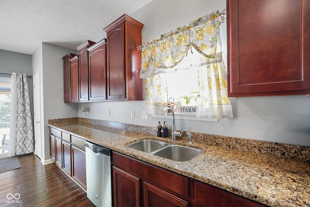 kitchen featuring dishwasher, a textured ceiling, dark hardwood / wood-style flooring, light stone counters, and sink