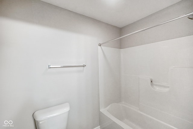 bathroom featuring toilet and  shower combination