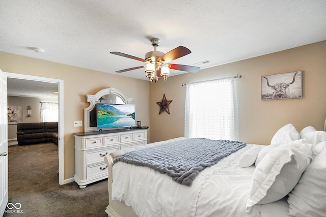 carpeted bedroom with a textured ceiling and ceiling fan