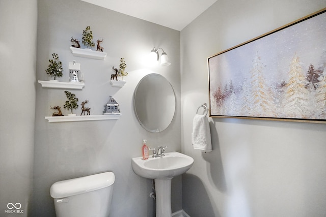 bathroom featuring toilet and sink