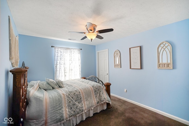 carpeted bedroom featuring a textured ceiling and ceiling fan