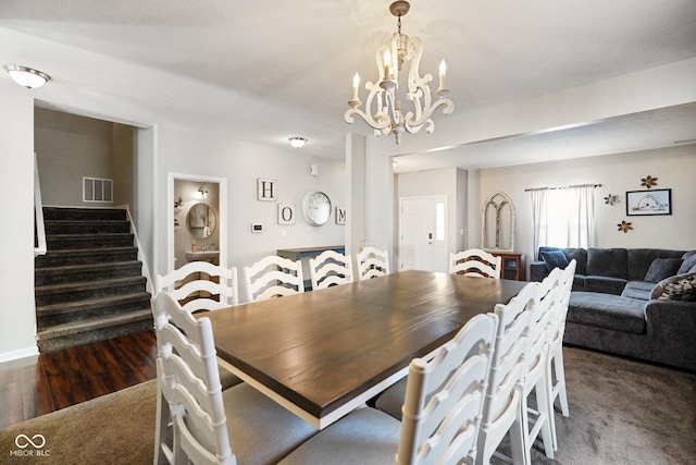 dining area with an inviting chandelier and dark hardwood / wood-style floors