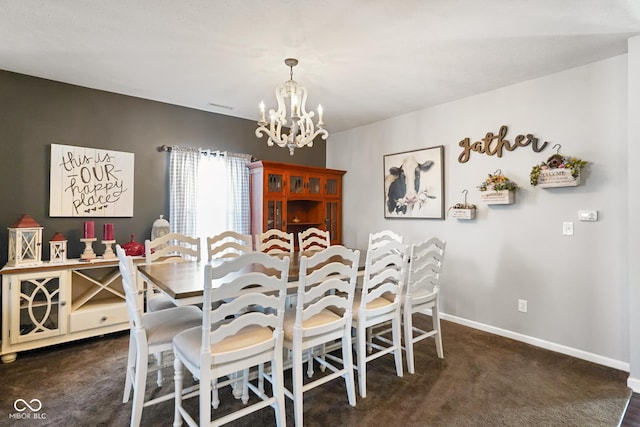 carpeted dining space featuring an inviting chandelier