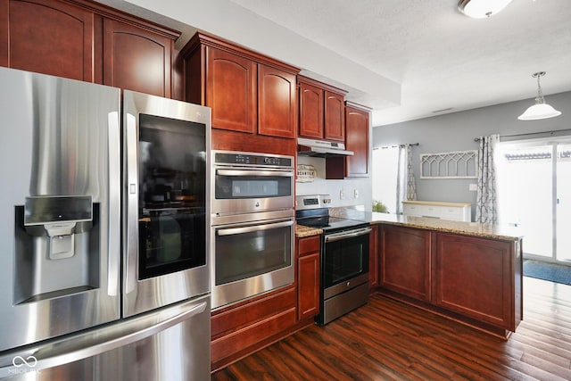 kitchen featuring stainless steel appliances, light stone counters, kitchen peninsula, dark hardwood / wood-style flooring, and pendant lighting