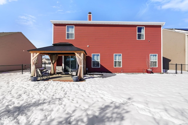 snow covered rear of property featuring a gazebo