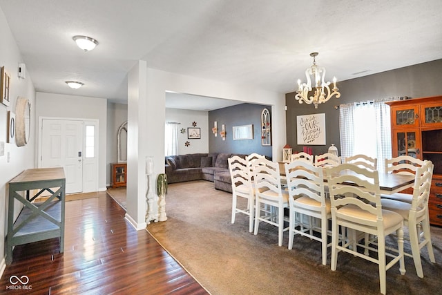 dining room with an inviting chandelier and dark hardwood / wood-style flooring