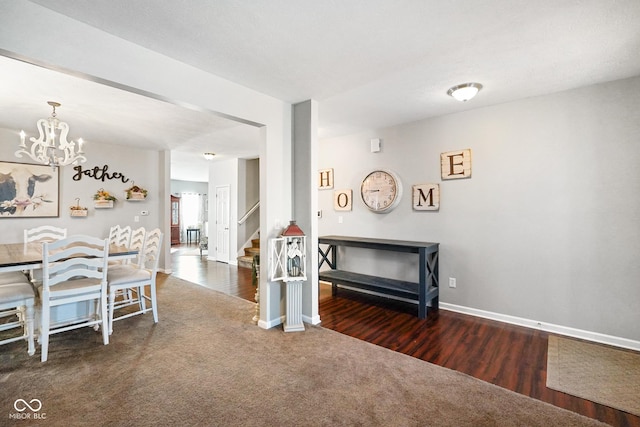 carpeted dining room with a notable chandelier