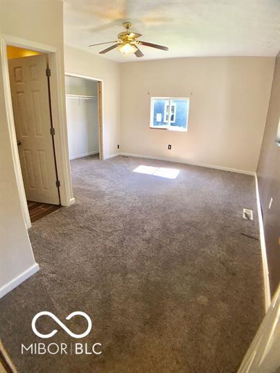 empty room with carpet and ceiling fan