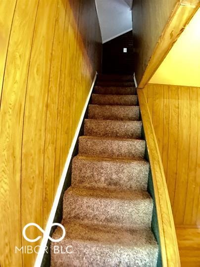 stairs featuring wooden walls