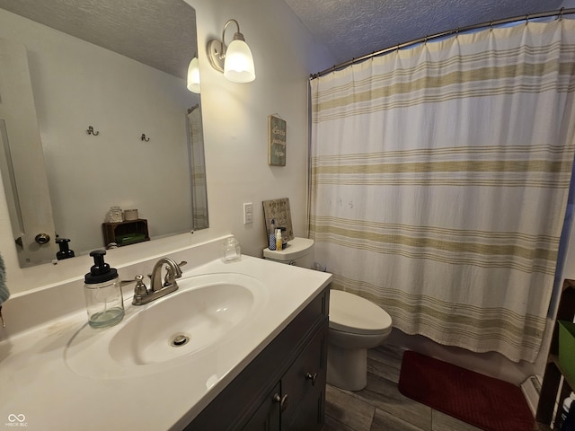 620 Valley Dr, Martinsville, IN 46151 - bathroom featuring toilet, vanity, a textured ceiling, curtained shower, and wood finished floors