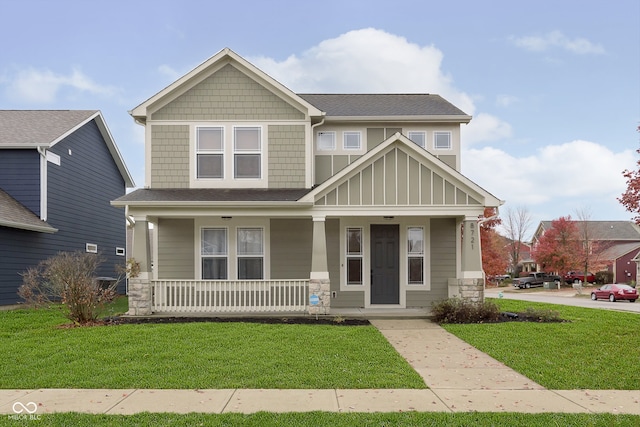 craftsman house with a porch and a front yard