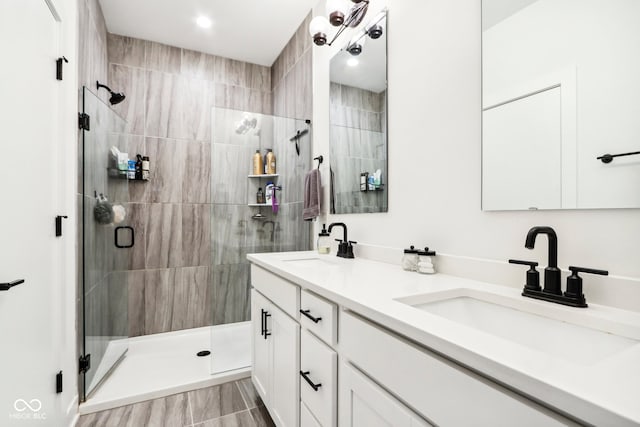 bathroom with vanity and a shower with door