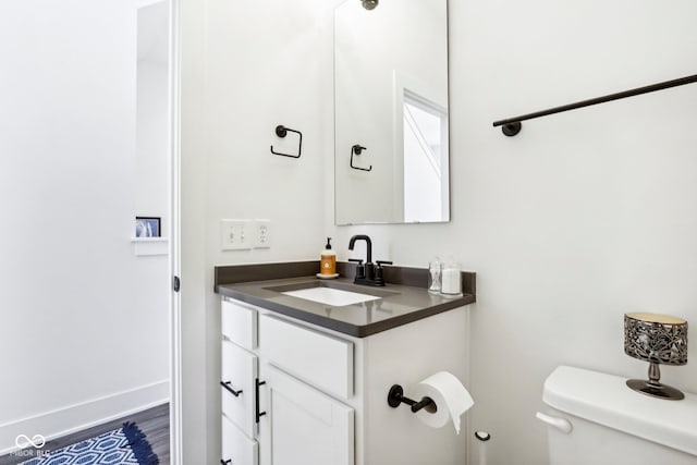 bathroom featuring hardwood / wood-style floors, vanity, and toilet