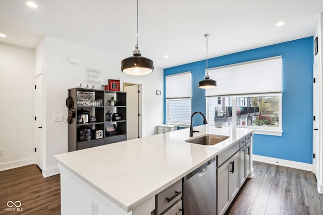 kitchen featuring pendant lighting, dishwasher, sink, dark hardwood / wood-style floors, and an island with sink