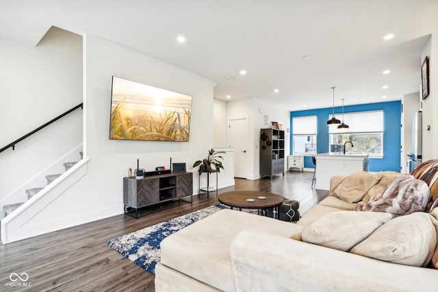 living room with dark hardwood / wood-style floors and sink