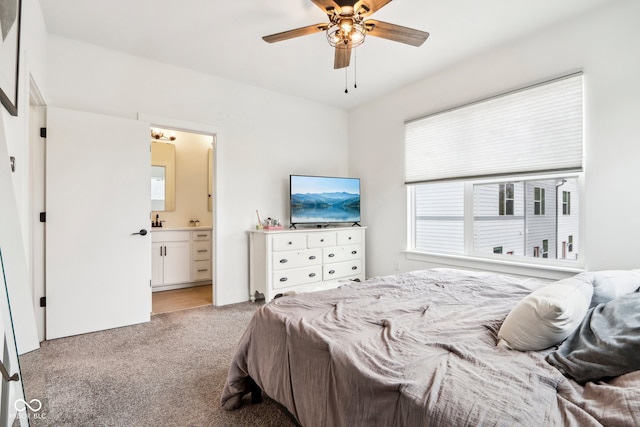 carpeted bedroom featuring ensuite bath and ceiling fan