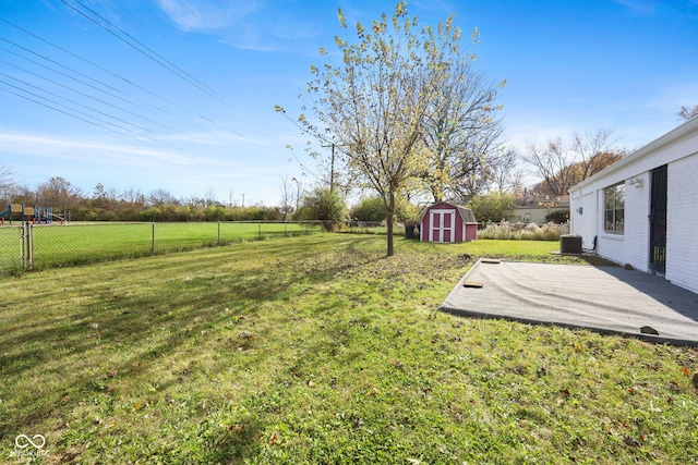 view of yard featuring a patio, cooling unit, and a storage shed