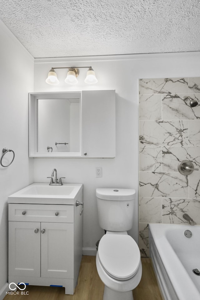 full bathroom with toilet, tiled shower / bath combo, a textured ceiling, hardwood / wood-style flooring, and vanity