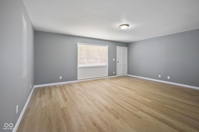 spare room featuring light hardwood / wood-style flooring