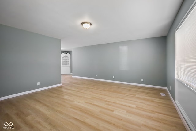 unfurnished room with light wood-type flooring