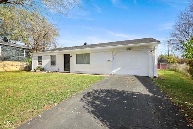 ranch-style house featuring a front yard and a garage