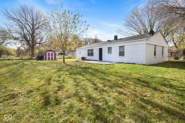 view of yard with a storage shed and a patio