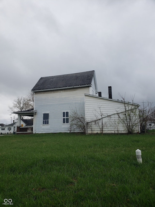 view of side of property with a yard