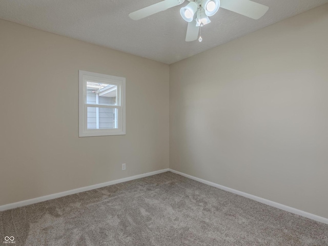 carpeted spare room with a textured ceiling and ceiling fan